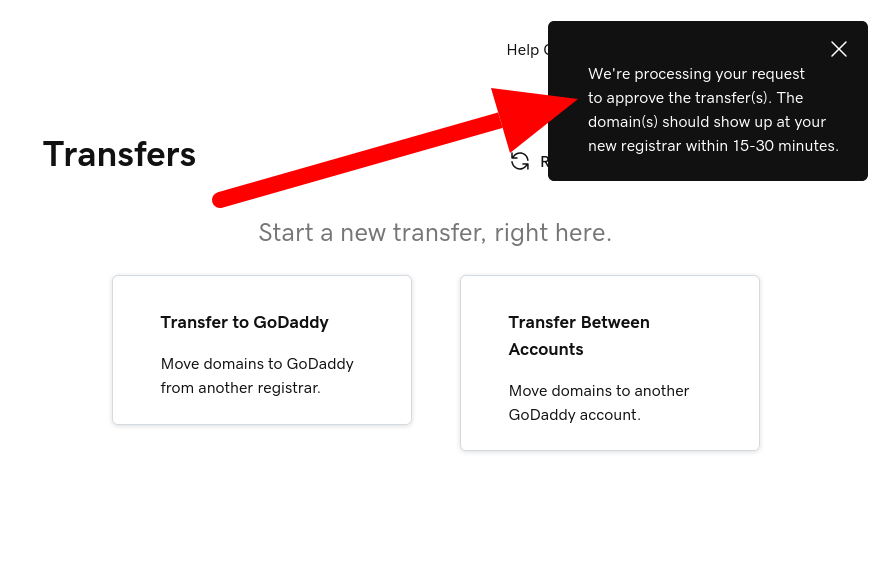 Screenshot of GoDaddy domain transfers page with arrow showing the domain transfer processing notification